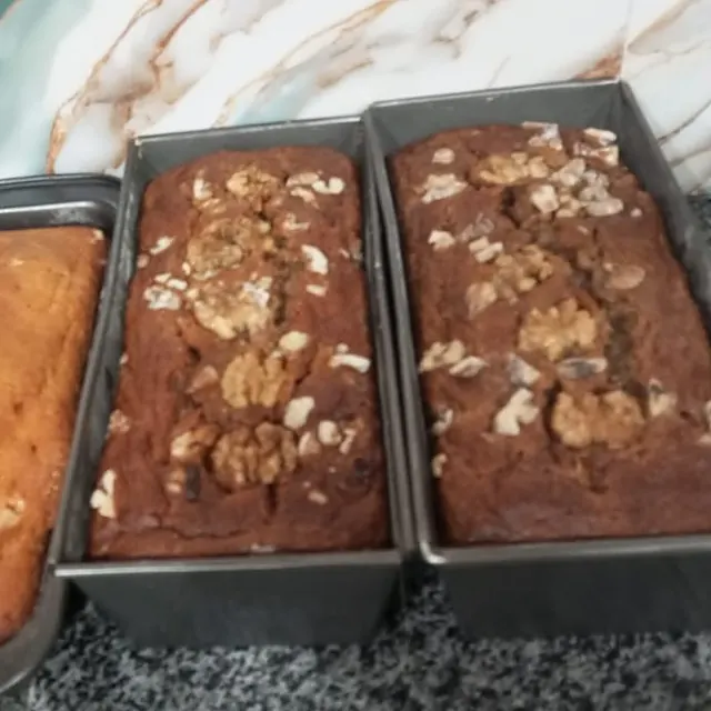Three tea loaves cooling in their tins