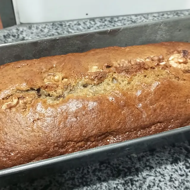 A walnut loaf cake in a baking tin